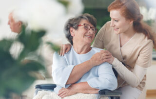 A senior woman and her caregiver talk and smile