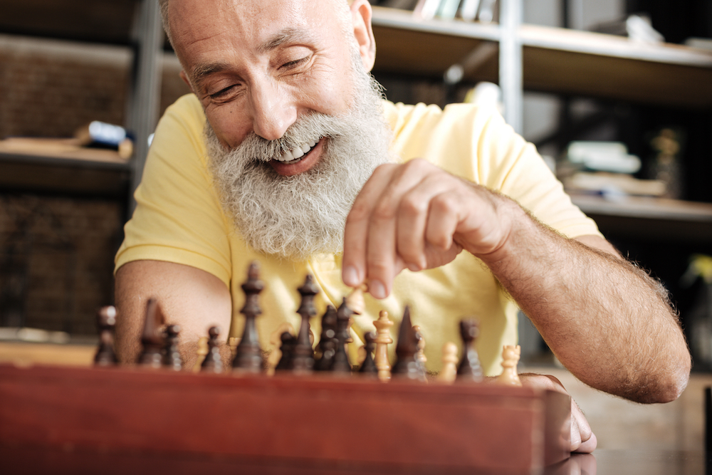 A senior man playing chess