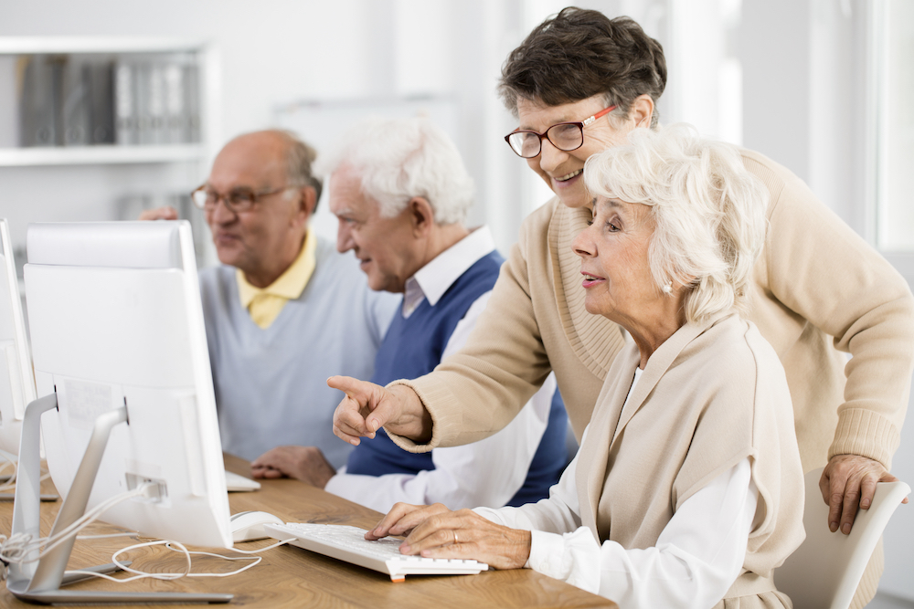 A senior woman taking a computer class